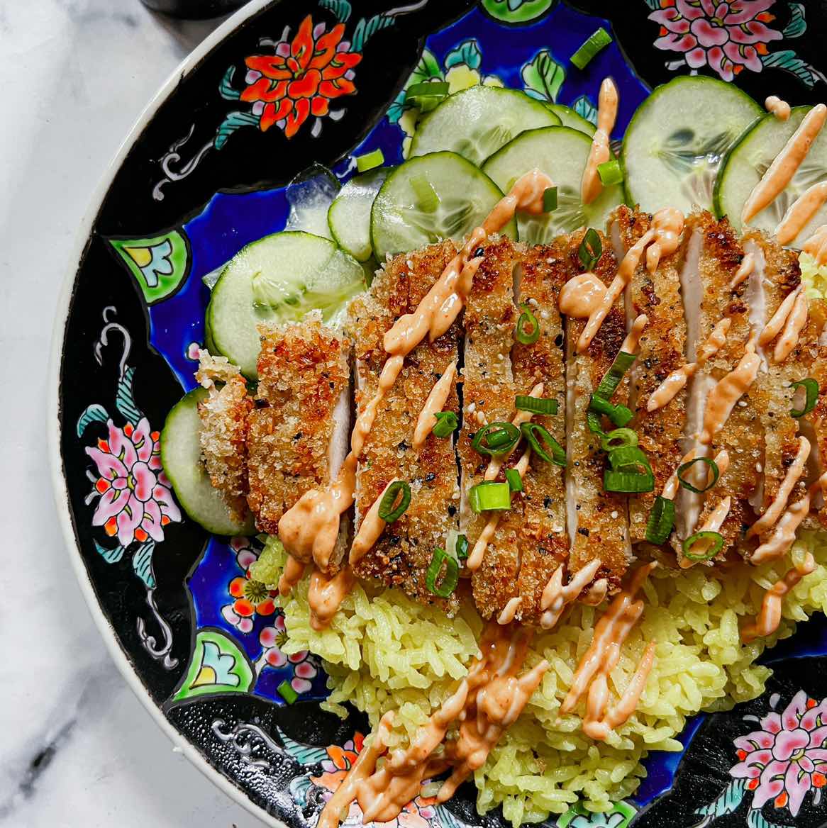Crispy chicken cutlets on golden coconut rice 